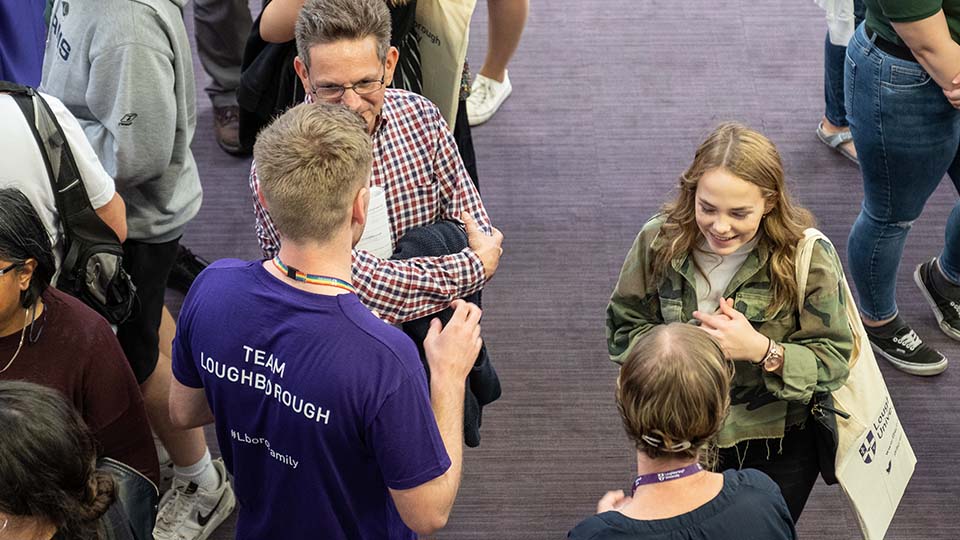 An ambassador talking to a parent on an open day.