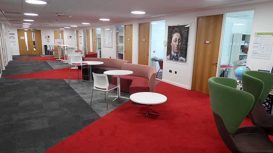 Sir David Davies DAV1219 - red and grey carpets with a mixture of seating and desk space.