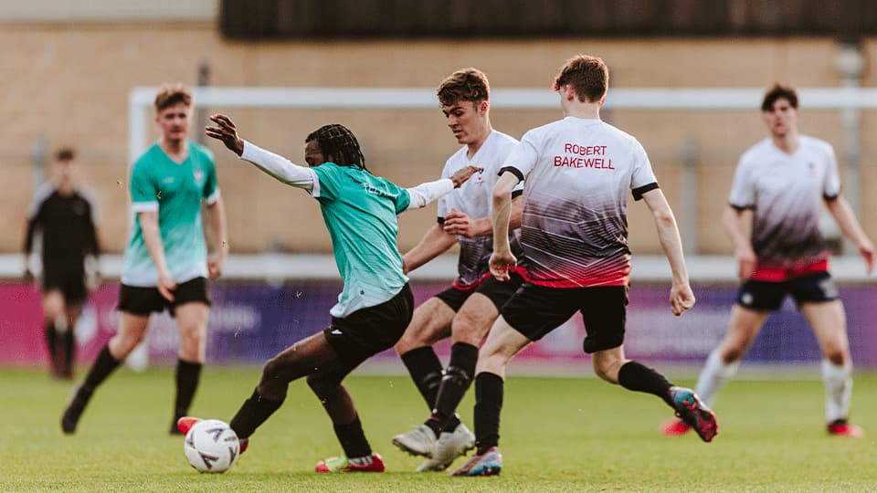 Football game - players kicking the ball on the pitch