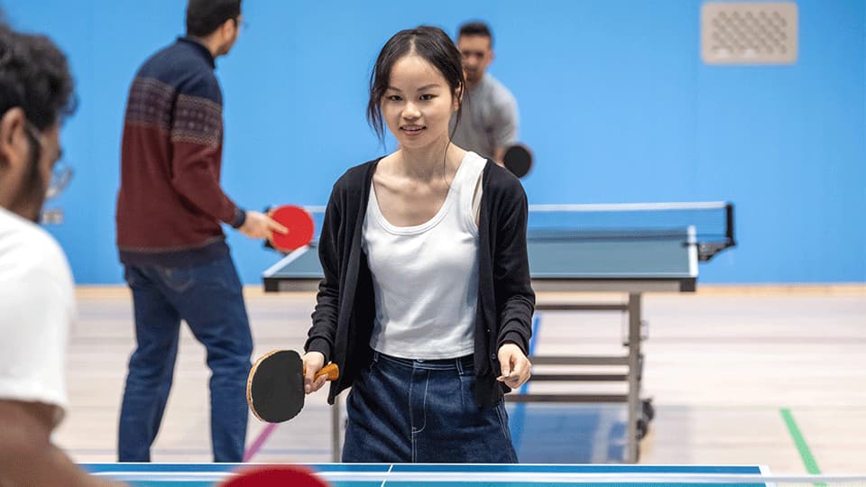 Students playing table tennis.
