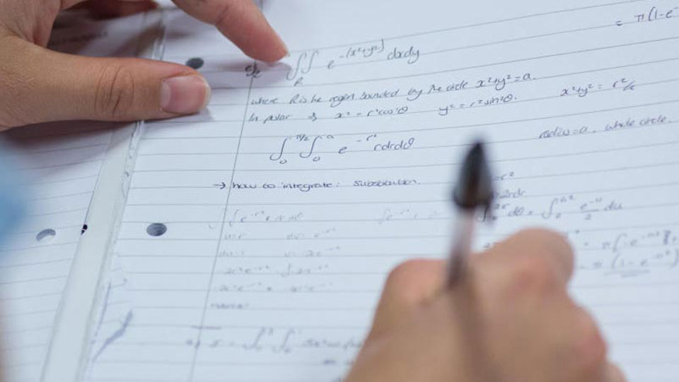 A hand writing mathematical formula