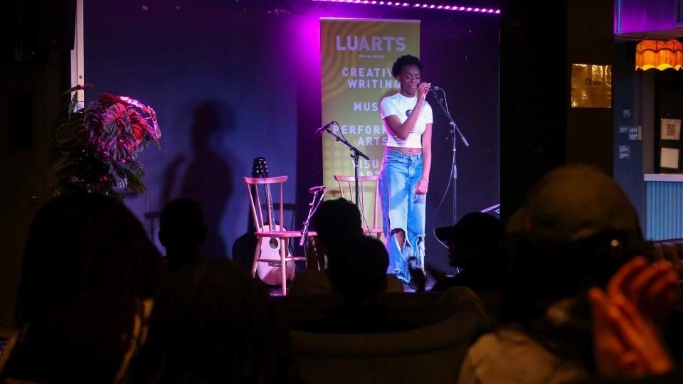 A performer singing on stage.