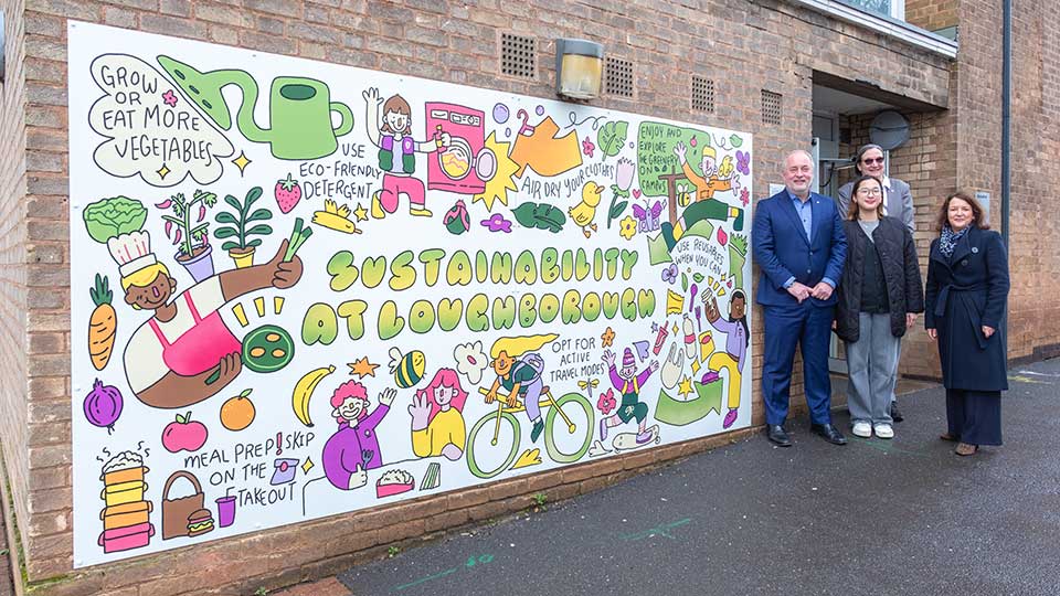 The Vice-Chancellor stood next to a student mural on campus.