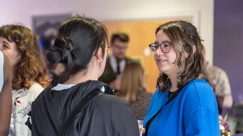 students at an event talking