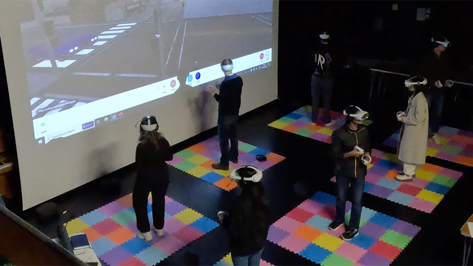 A group of students with VR headsets taking part in immersive VR teaching