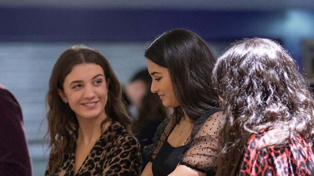 three students talking