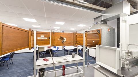 Table wind tunnel with model cars on a desk