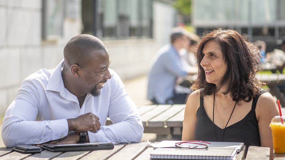 two students sitting outside