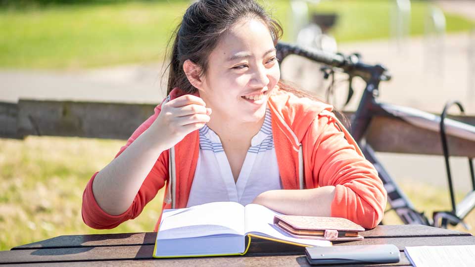 a woman sitting outside reading