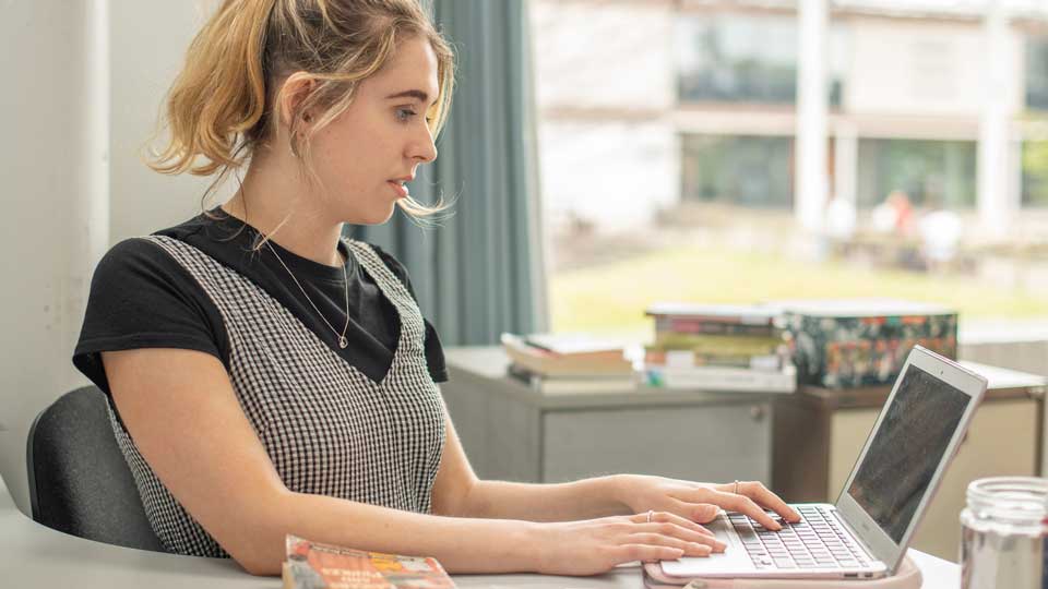 a student using a laptop computer