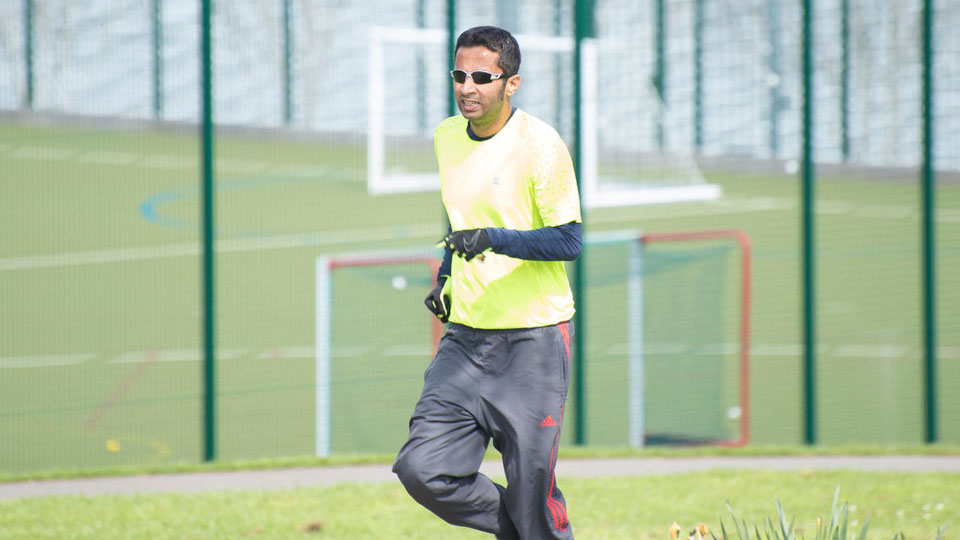 Coach running across field