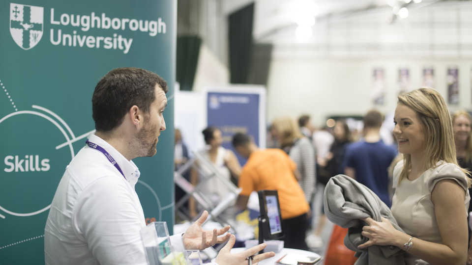 a woman talking to the man on the Loughborough University stand