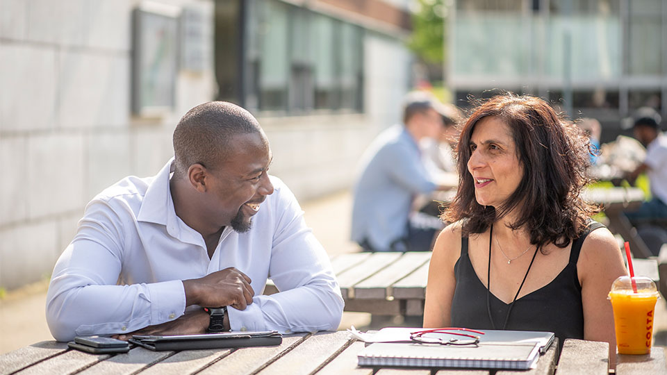 Two students sitting outside