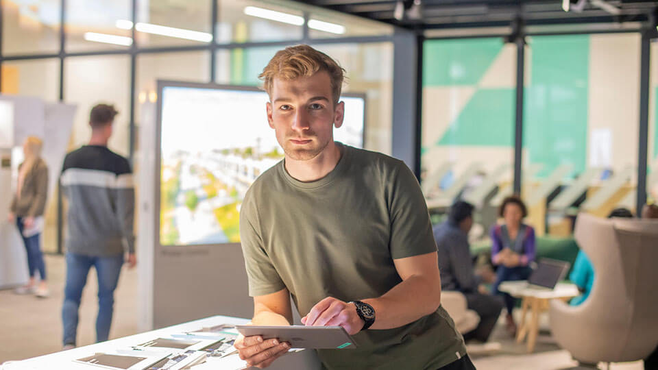 Student stood holding documents