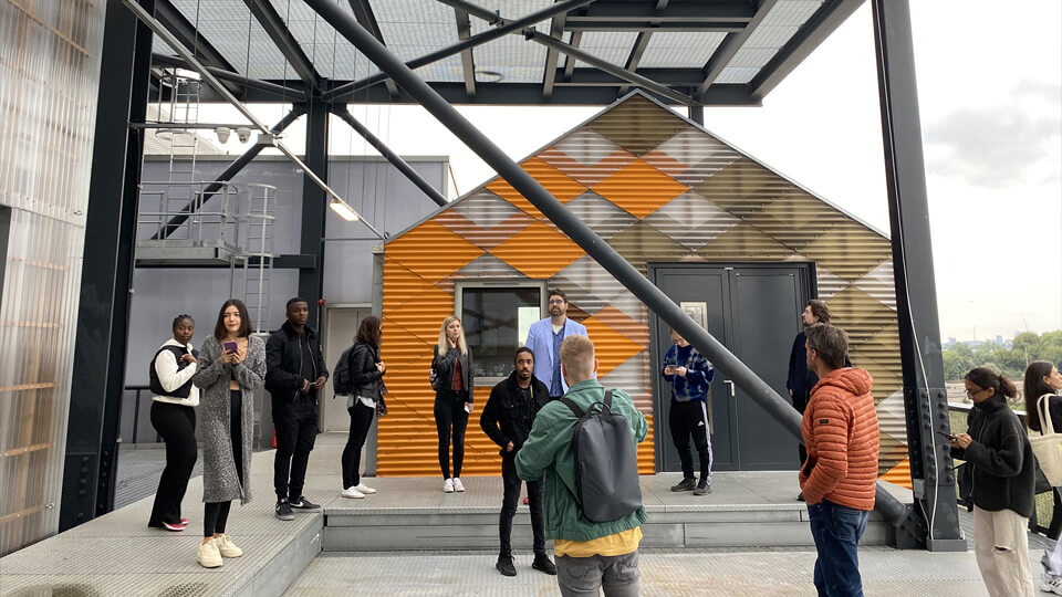 Students and staff outside looking around at the building structure at the Gantry site visit with Hawkins\Brown Architects.