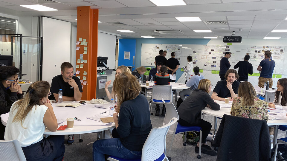 Students sat around tables in groups while listening to industry professionals.