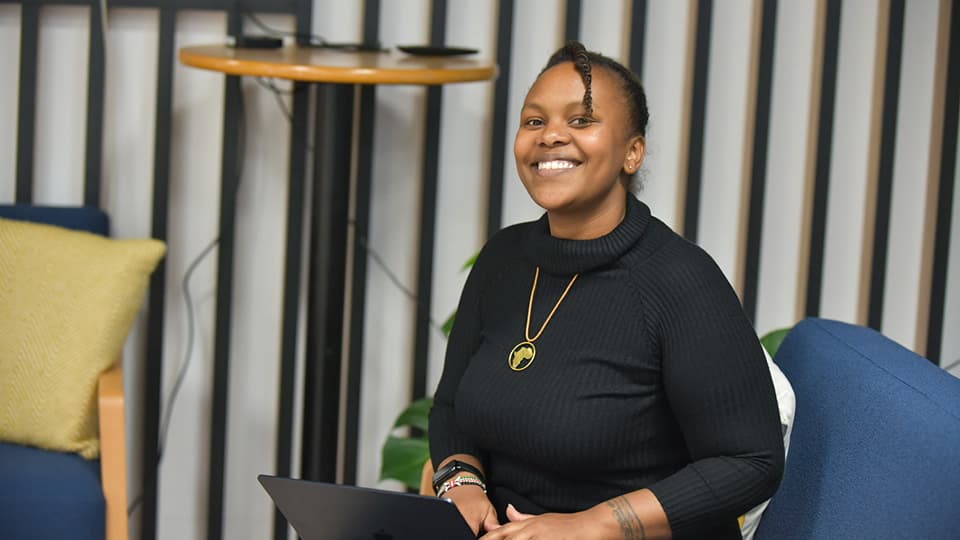 Serah sat down with a laptop, smiling to camera