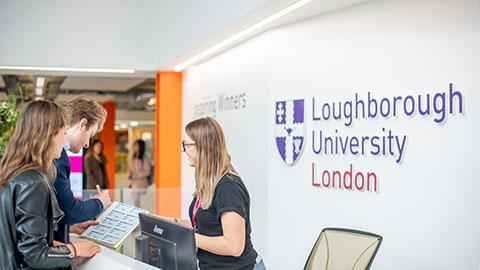 Two students talking to a member of staff at Loughborough University London