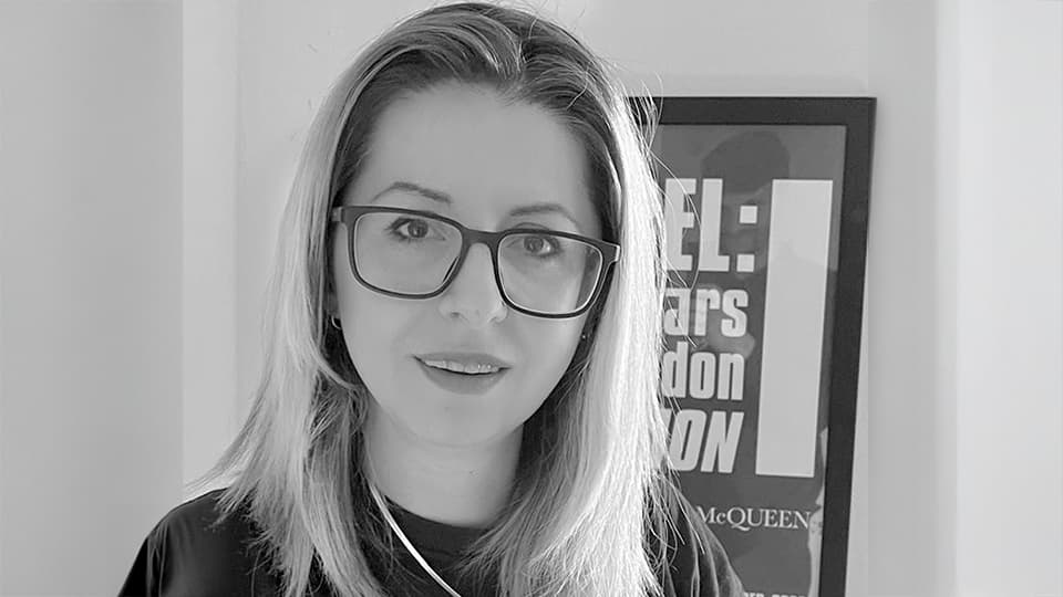 Alis stood against grey background and picture frame