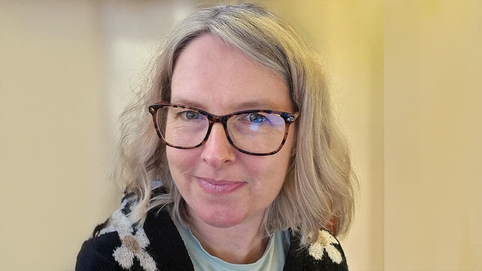 Amy stood against a cream background