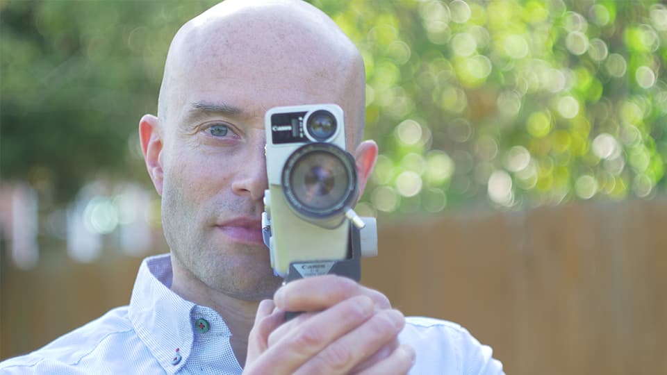 André stood outside with a camera