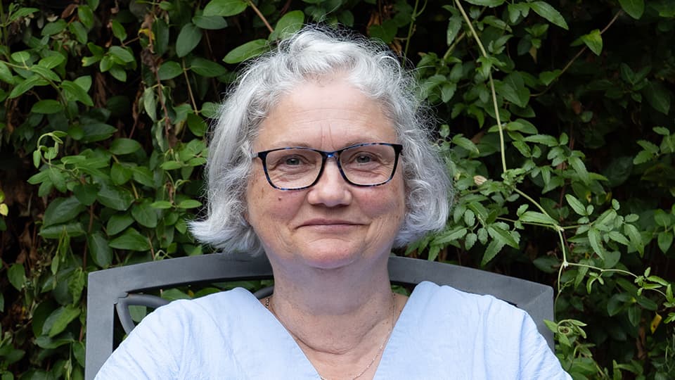 Clare sat by some trees