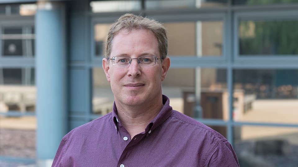 Dominic stood in front of glass windows