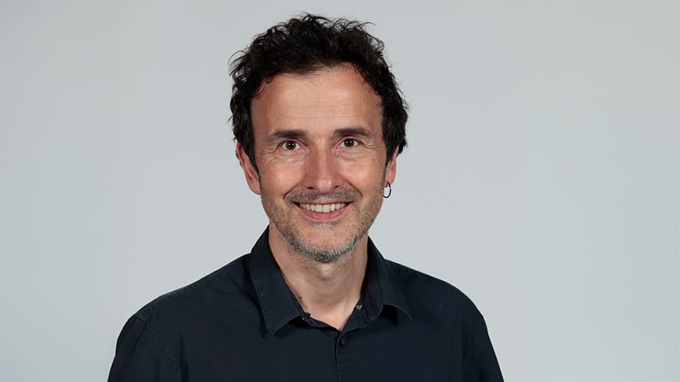 Fred stood against a grey background