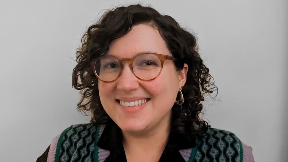 Holly stood against a grey background