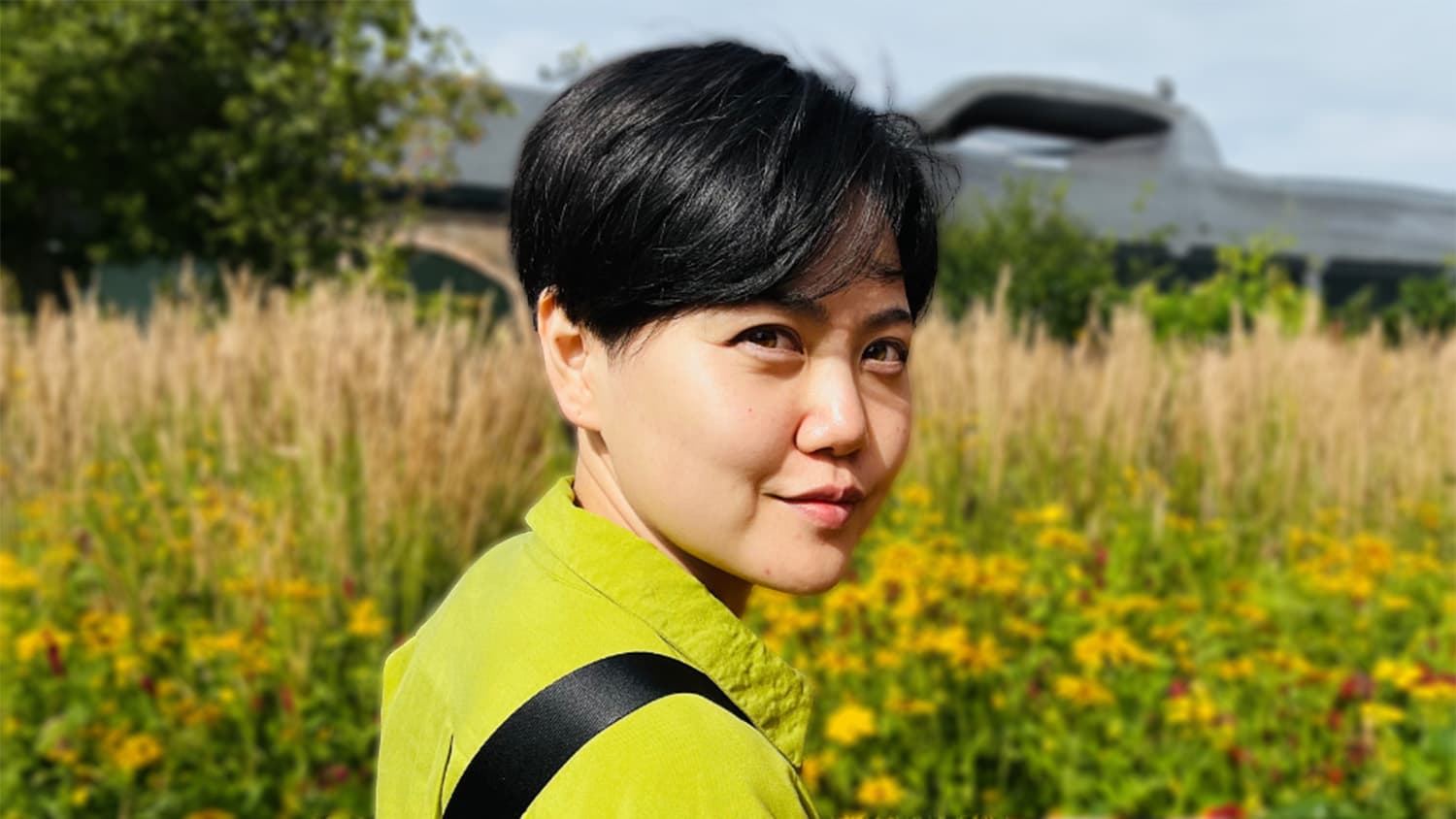 Karen stood outside by long grass