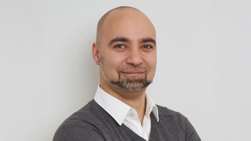 Korbinian stood against a grey background