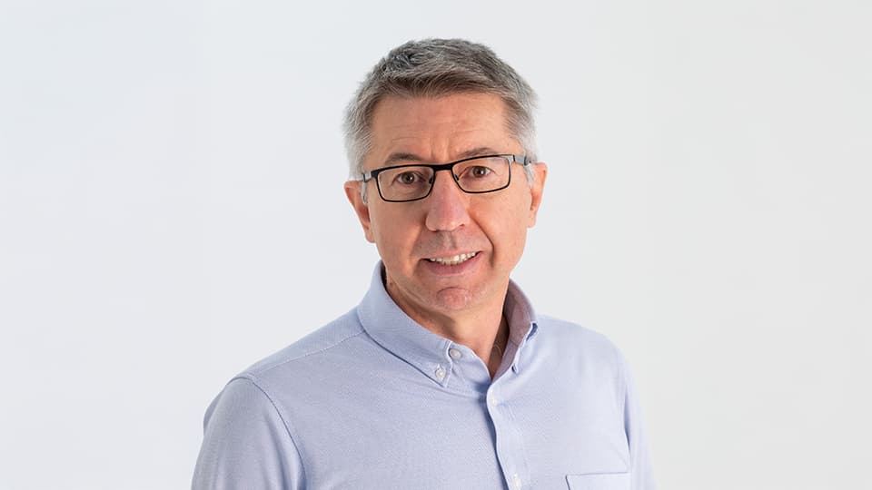 Marco stood against a grey background