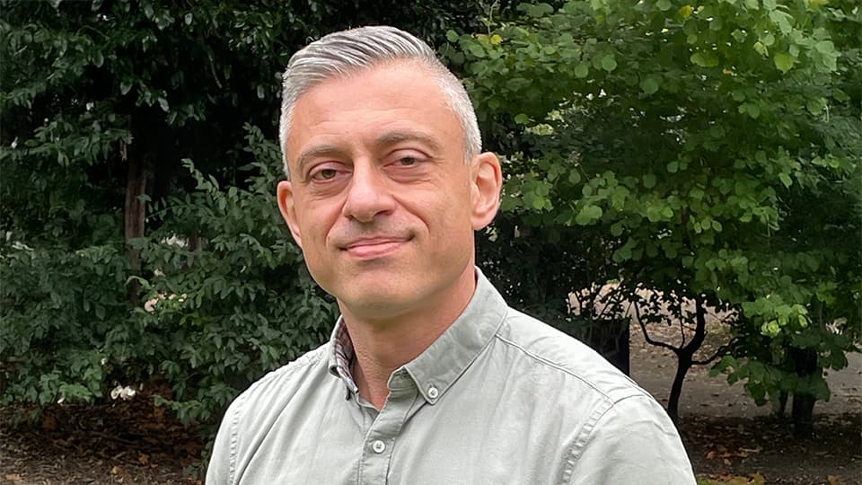 Marco stood in front of trees