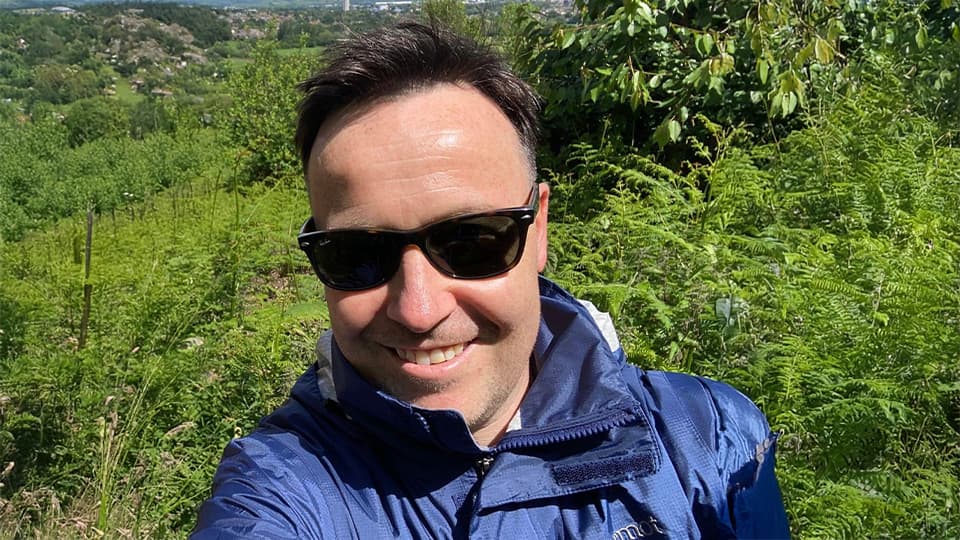 Mark stood by some trees