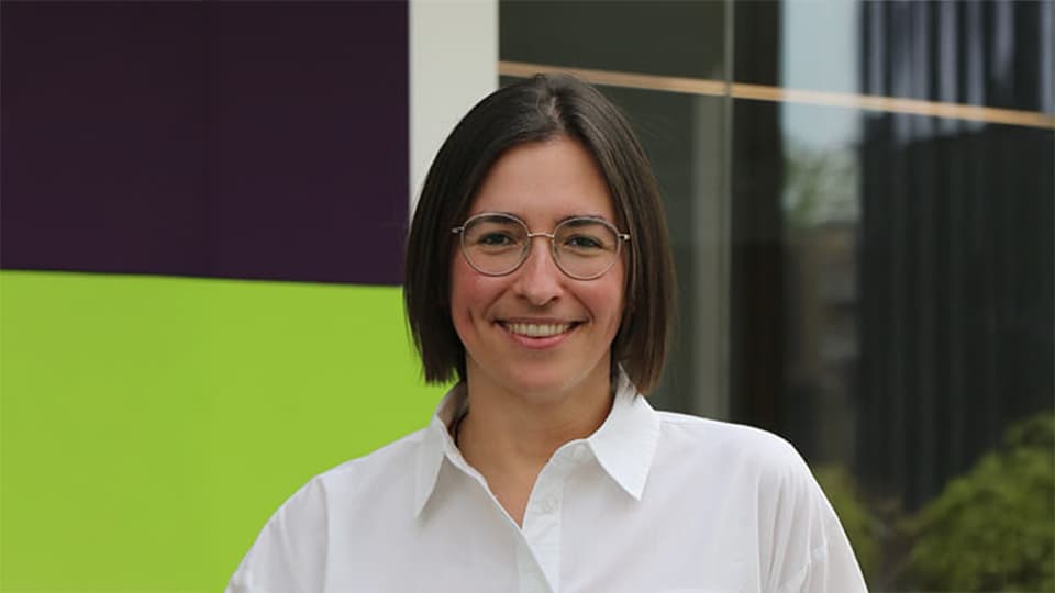 Nicola stood in front of glass windows