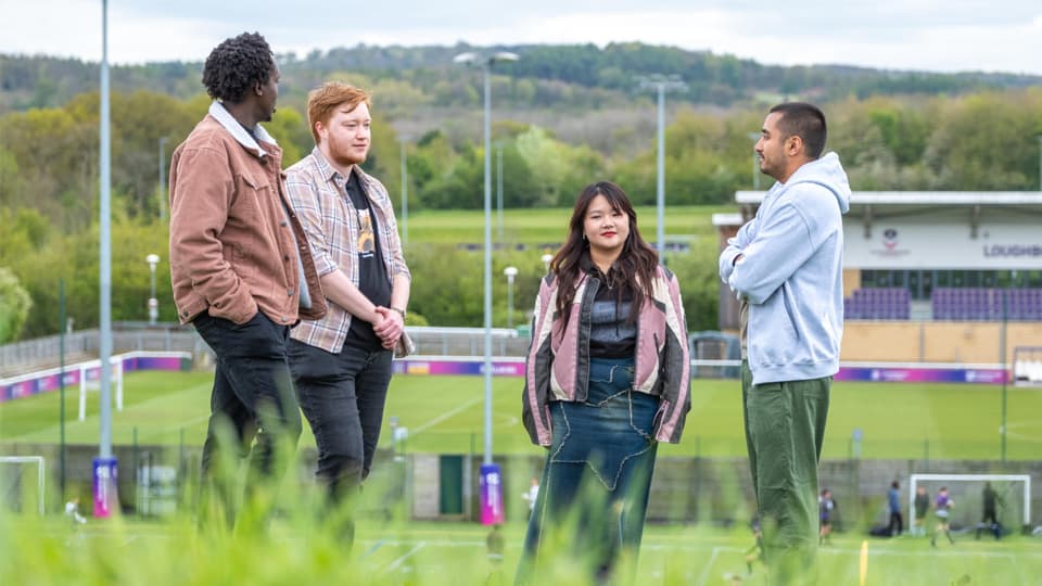 A a group of postgraduate students talking outside