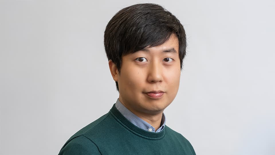 Taeyoung stood next to a grey background