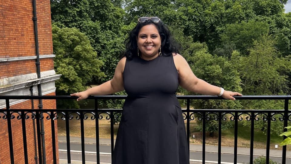 Hasulie standing on a balcony