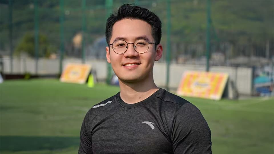 Jianhao stood by grass field