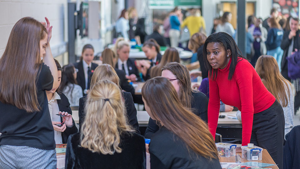 Advice and top tips. Students conversing with teachers.