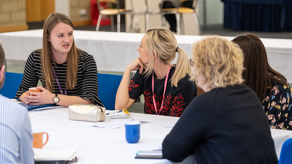 Register interest for school and college staff. Teachers engaged in conversation.