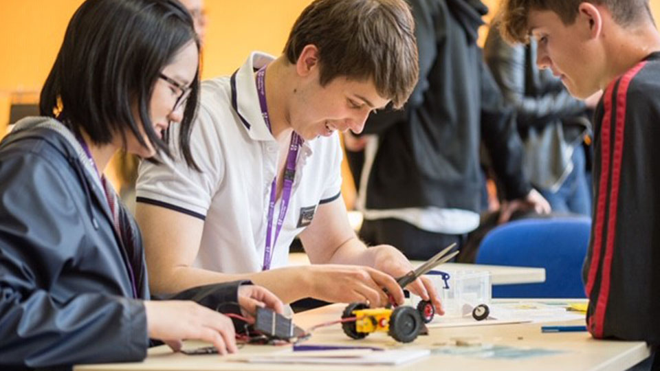 Subject in a box. Students engaging in an electronics activity.
