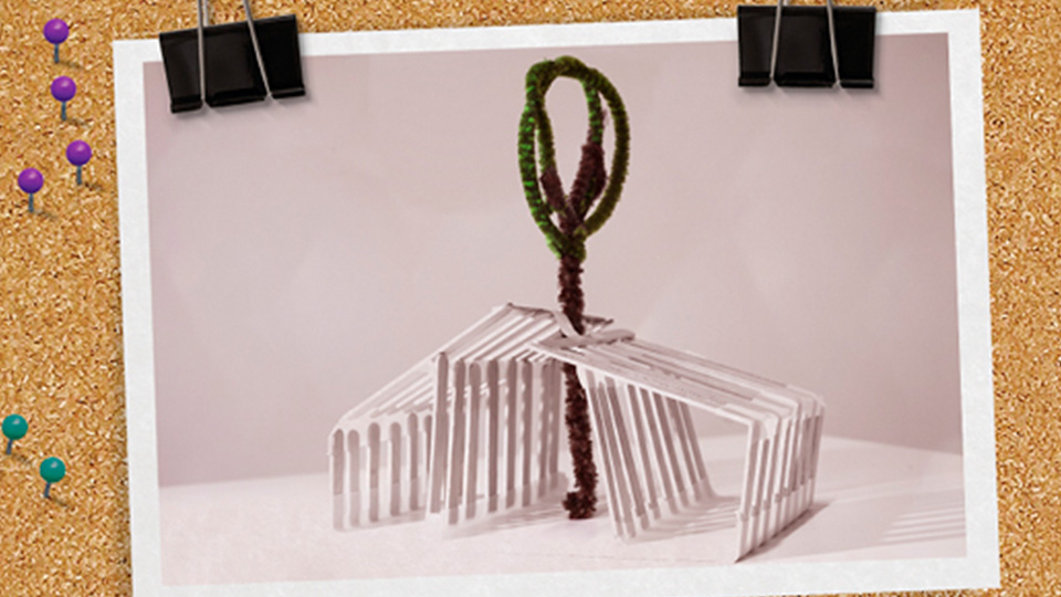 photo of an architecture model clipped to a notice board