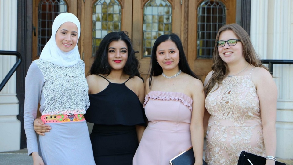 Leah and three friends standing outside the doors of Hazlerigg before summer ball.