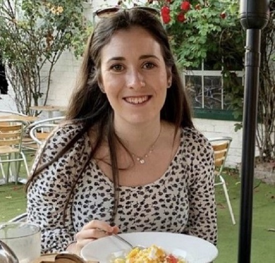 Olivia outside eating a meal.