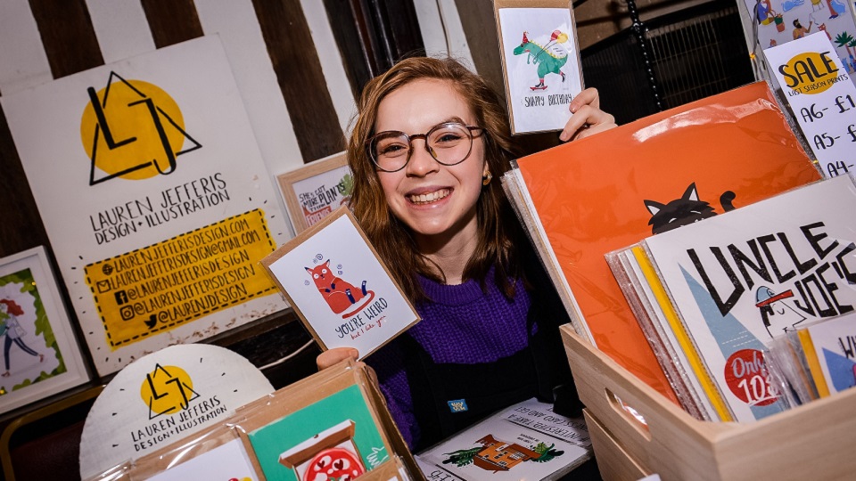 Lauren with her designs and prints that she has illustrated and produced. 