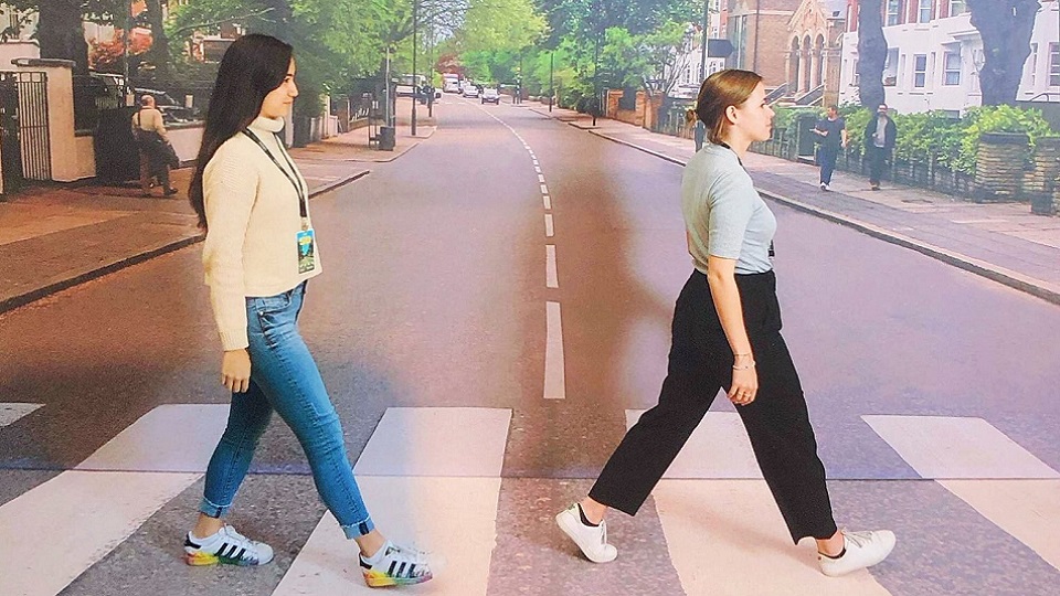 Lety and a colleague in front an Abbey Road backdrop which was made famous by The Beatles album cover.