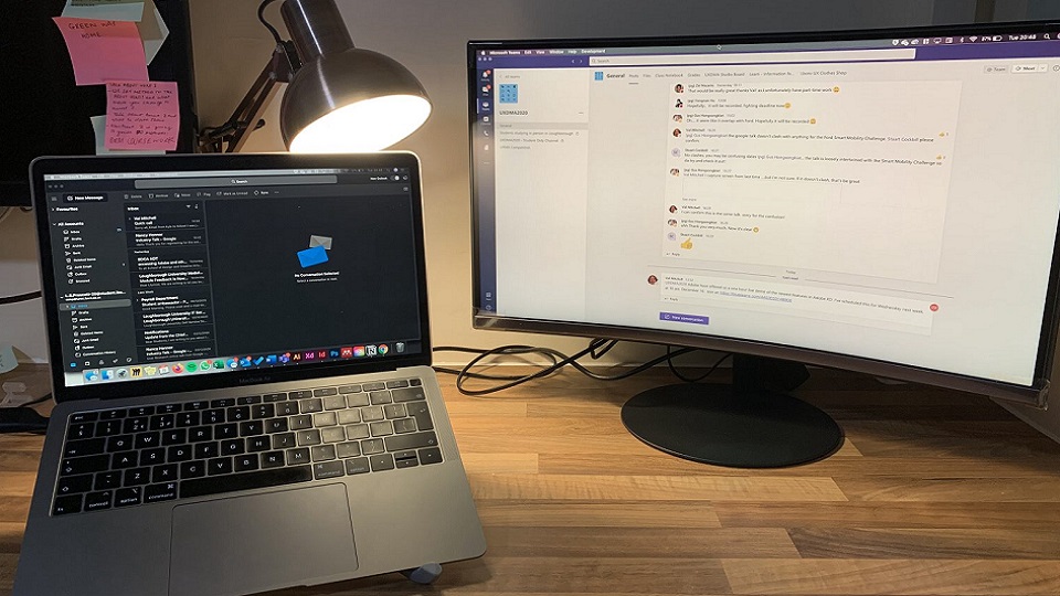 Lilymae's working station with her laptop and a computer screen next to each other on a desk. 