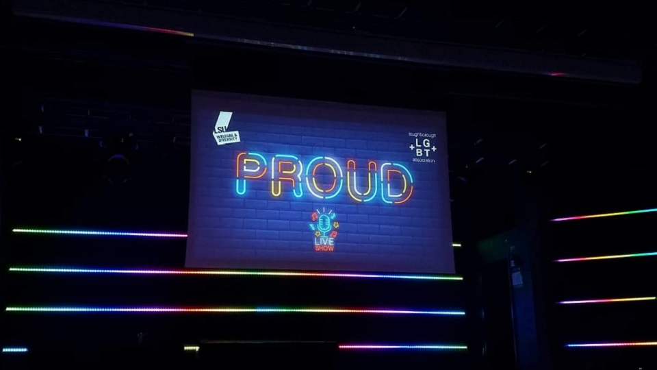 The word proud displayed on an LED screen in Room 1 in Loughborough Students Union.