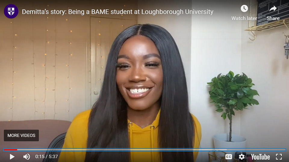 Screenshot from Demitta's vlog, where she it sitting in her bedroom talking to the camera. 